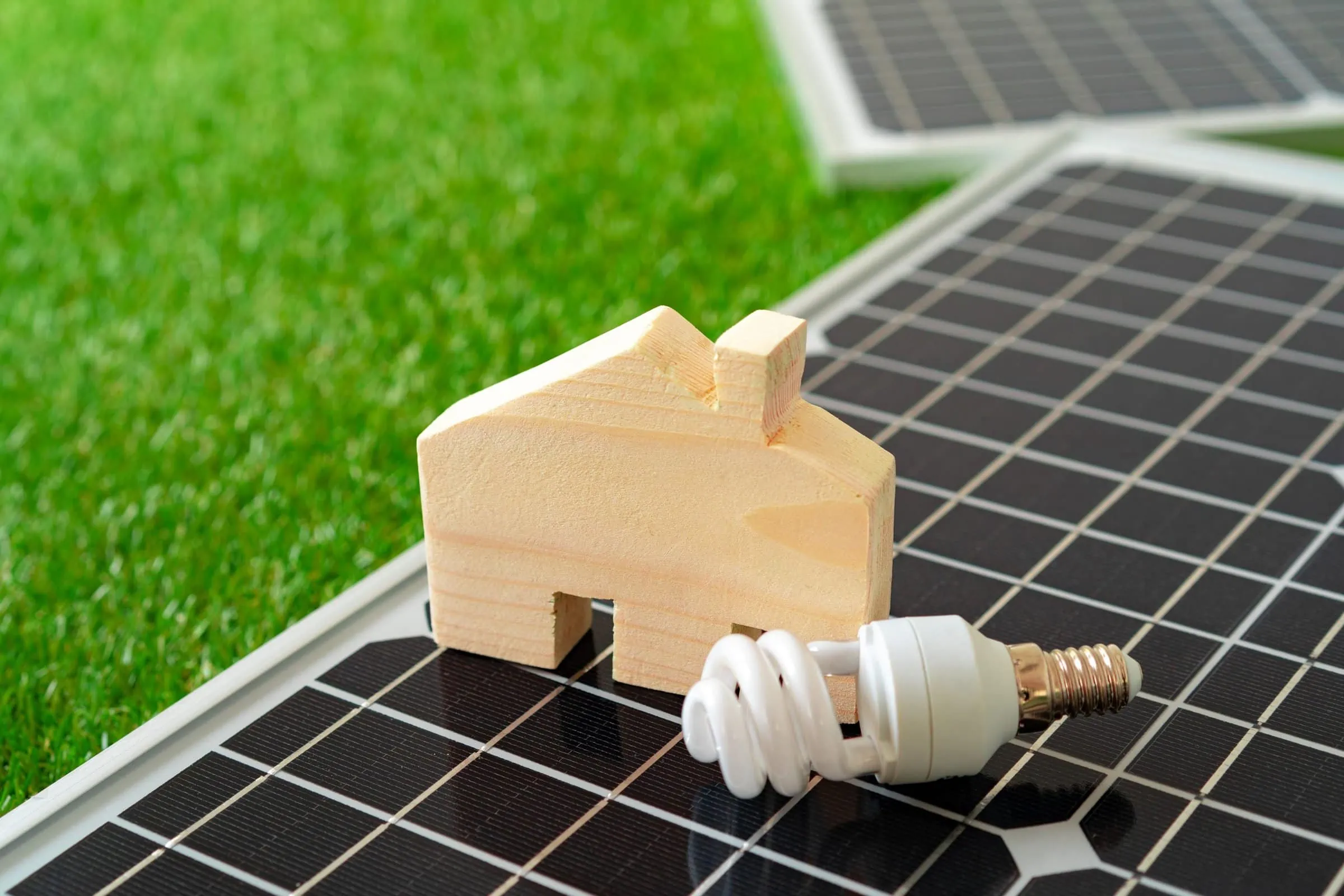 wooden house miniature and solar panel close up 2021 09 03 17 39 54 utc scaled