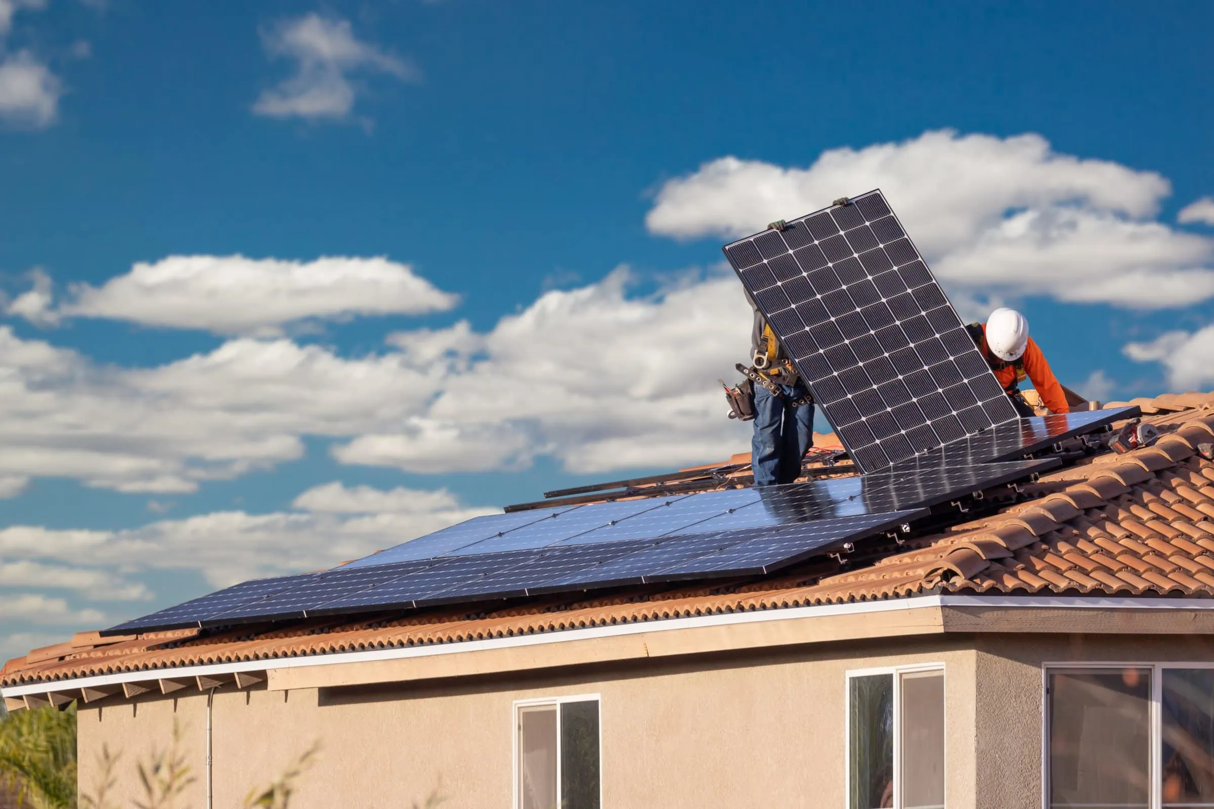 workers installing solar panels on house roof 2022 10 17 01 16 16 utc scaled